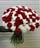 Траурный букет из 100 красных и белых гвоздик